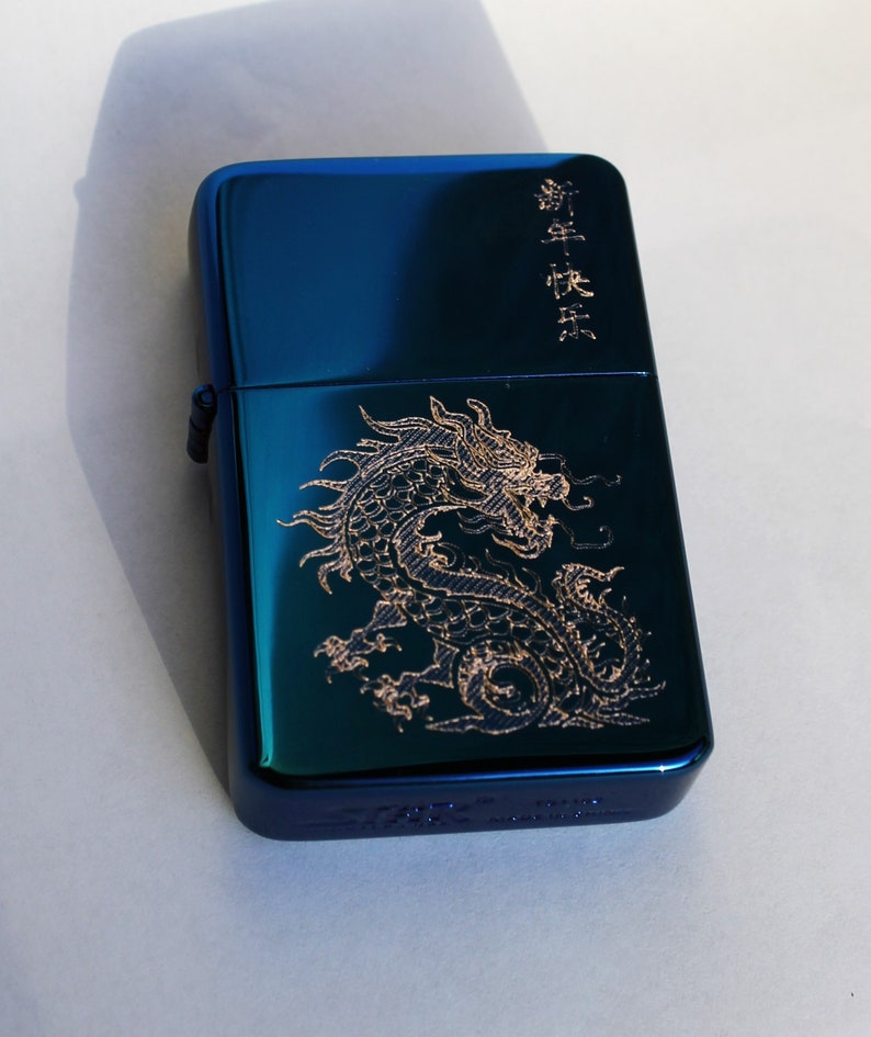 May include: A blue lighter with a gold dragon design and the text "龍年大吉" in gold lettering.