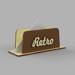 May include: A brown and yellow wooden napkin holder with the word "Retro" in yellow lettering.