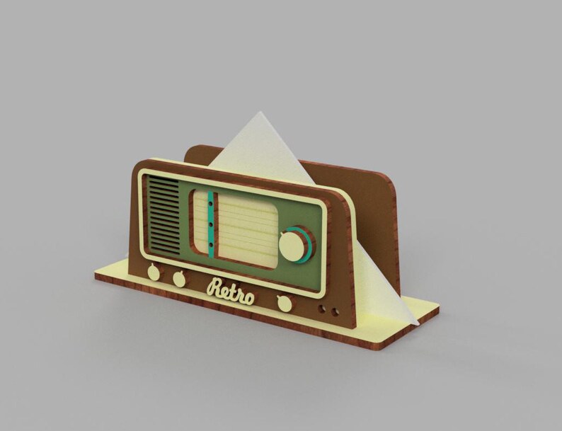 May include: A wooden napkin holder shaped like a vintage radio with a green face, brown knobs, and the word "Retro" printed on the front.