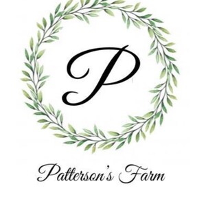 May include: A green leafy wreath with a black letter "P" in the center. The text "Patterson's Farm" is below the wreath.