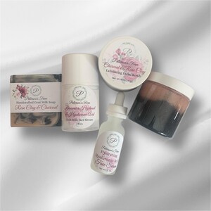 May include: A set of four skincare products in a white and pink colour scheme. The products include a bar of soap, a face cream, a facial scrub, and a face serum. The products are labelled with the name "Patterson's Farm" and the ingredients "Rose Clay & Charcoal", "Rosewater Hydroul & Hyaluronic Acid", "Charcoal & Rose Clay", and "Hydrating Hyaluronic Acid".