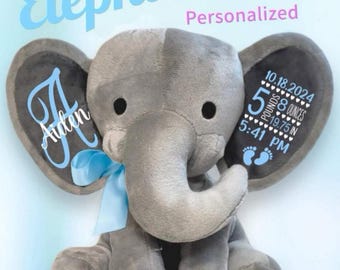May include: A gray plush elephant toy with a light blue ribbon around its neck. The left ear features the name Aiden in blue script. The right ear displays birth stats: 10.18.2024, 5 pounds 8 ounces, 19.75 in, and 5:41 PM with two blue footprints.