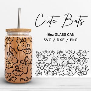May include: A glass can with a wooden lid and a metal straw, decorated with a repeating pattern of smiling cartoon bats. The words "Cute Bats" are written in a script font. The glass can is 473ml.