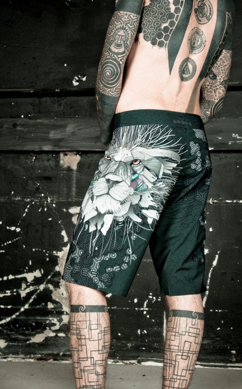 May include: Black and green athletic shorts with a white lion graphic print. The lion has a geometric design and a detailed face.