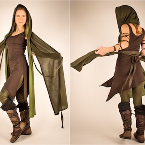 May include: A woman wearing a brown and green hooded tunic with a long green scarf. The tunic has a long, flowing skirt and a fitted bodice. The scarf is tied around the waist and flows behind the woman.