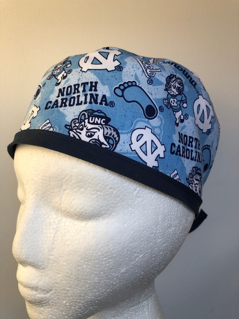 May include: A blue and white patterned surgical scrub hat with the text "North Carolina" and the UNC logo.
