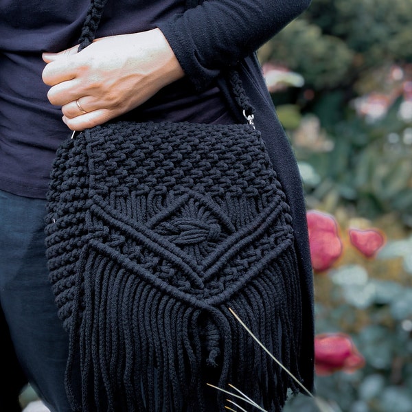 Casual black macrame crossbody bag, medium-sized  handbag woven from a string with tassels.