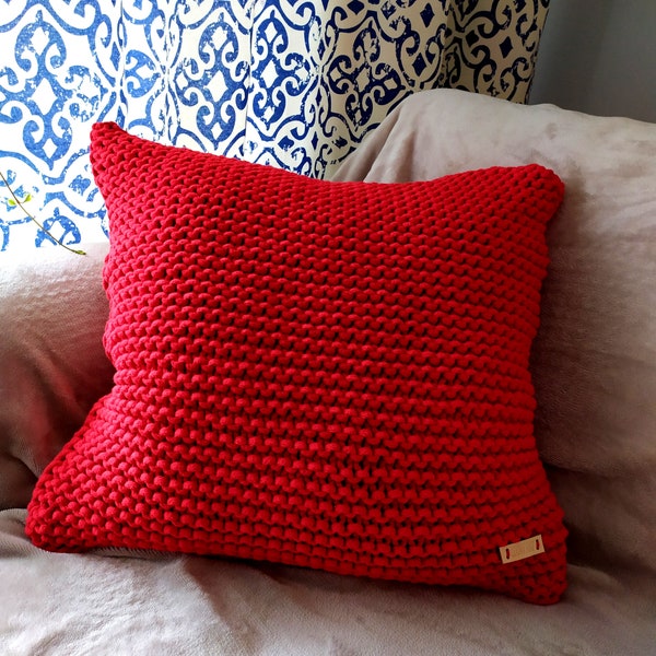 Decorative, knitted red pillowcase 50x50cm. for interior design in a boho or rustic style. Handmade rope pillow to decorate the sofa.