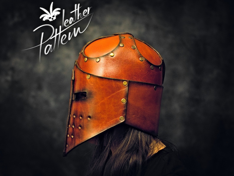 May include: A brown leather helmet with a visor, featuring a horizontal eye slit and circular ventilation holes on the side. The helmet is constructed from multiple leather panels joined by brass-colored metal rivets. The text Pattern Leather is visible.
