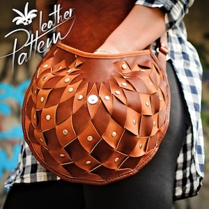 May include: A brown leather shoulder bag with a unique woven design and silver studs. The bag is being worn by a person with a plaid shirt.