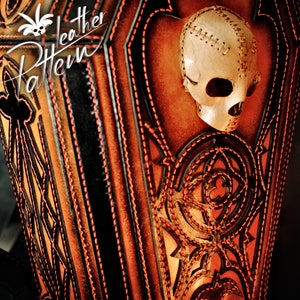 May include: A brown leather bag with intricate stitching and a skull design. The bag has a strap and is decorated with a skull with stitched details. The bag is made of leather and has a dark brown colour.