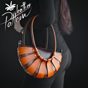 May include: A brown leather handbag with a unique woven design. The bag has a curved shape and a top handle.