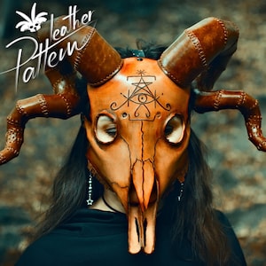A cultist woman robed in black, wearing a horned animal skull mask made out of leather in the style of esoteric symbolism, dark orange and beige, imitating burnished bone and holding a staff adorned with human skulls made out of leather