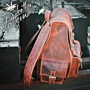 May include: A brown leather backpack with a flap closure and multiple pockets. The backpack has a distressed look and is made of high-quality leather.