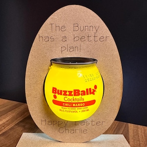 May include: A wooden Easter egg-shaped display with a yellow BuzzBallz cocktail can. The text on the display reads "The Bunny has a better plan!" and "Happy Easter Charlie". The can is 200 ml.