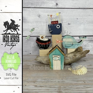 May include: A set of four wooden nautical-themed decorations, including a blue and red boat, a blue whale, a blue and white beach hut, and a red and black boat. The decorations are on a wooden surface with a seashell.