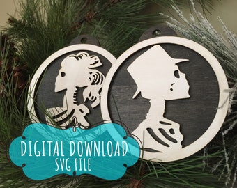 May include: Two wooden Christmas ornaments with a black background and white skeleton figures. The ornaments are shaped like circles and have a hole at the top for hanging. The text "DIGITAL DOWNLOAD SVG FILE" is visible in the image.