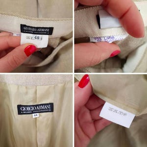 Puede incluir: Primer plano de un pantal&oacute;n beige de Giorgio Armani. Las etiquetas muestran la marca, la talla 48 y la composici&oacute;n de la tela. El forro interior es de color beige a juego. Las etiquetas tambi&eacute;n incluyen instrucciones de lavado.