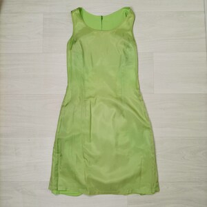 May include: A sleeveless lime green dress with a scoop neck and a simple, fitted silhouette.
