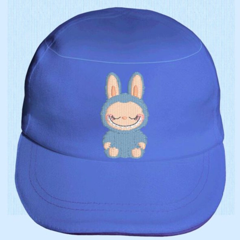 May include: A blue baseball cap with an embroidered cartoon bunny design. The bunny is light blue with pink ears and a smiling face. The cap has a curved peak and a rounded crown, suitable for various head sizes.