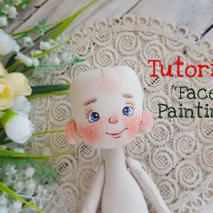 May include: A tutorial on doll face painting, showing a close-up of a doll's head with painted blue eyes, rosy cheeks, and a smile. The doll is sitting on a white lace doily.