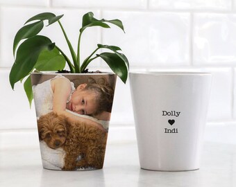 May include: White ceramic planter with a photo of a young girl and a puppy printed on the front. The text "Dolly ♥ Indi" is printed on the planter.