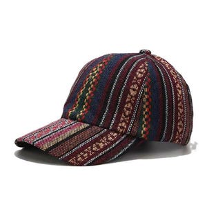 May include: A baseball cap featuring a woven fabric with vertical stripes in shades of dark blue, red, green, and cream. The cap has a structured crown and a curved brim, with the multi-colored striped pattern continuing consistently across the entire surface.