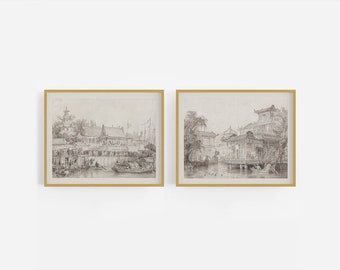 Op de afbeelding: Twee zwart-witte ingelijste prints van traditionele Chinese architectuur. De prints tonen een scène van een drukke waterkant met boten en mensen, en een meer serene scène van een pagode omringd door bomen.