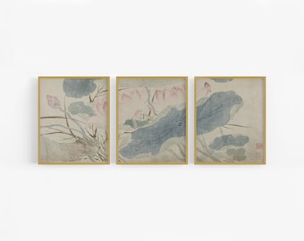 May include: A set of three framed prints featuring a traditional Japanese style painting of lotus flowers in shades of pink, blue, and green. The prints are framed in gold.