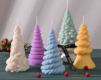 May include: Five Christmas tree shaped candles in different colors and designs. The candles are white, light blue, light purple, light green, and yellow.