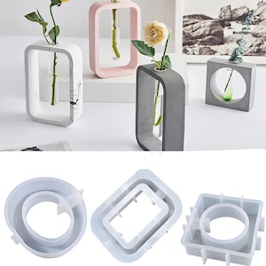 May include: Three silicone molds for making concrete vases. The molds are white and have different shapes: a square, a rectangle, and a circle.
