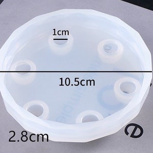 May include: A clear silicone mold with six round indentations for making resin crafts. The mold is 10.5 cm in diameter and 2.8 cm high. The indentations are 1 cm in diameter.