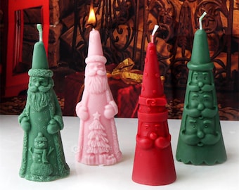 May include: Four Christmas-themed candles in the shape of a cone. The candles are green, pink, red, and green. The green candles have a Santa Claus design, the pink candle has a Santa Claus design with a Christmas tree, and the red candle has a Santa Claus design with a belt.