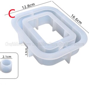 May include: A clear silicone mold for making resin crafts. The mold is shaped like a rectangle with a smaller rectangle inside. The mold measures 12.8 inches by 16.6 inches. There is also a smaller round mold that measures 1.7 inches in diameter and 2.1 inches in height.