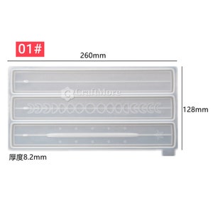 May include: A clear silicone mold with three different designs: a single line, a row of circles and crescents, and a line with stars. The mold is 260mm long, 128mm wide, and 8.2mm thick.  The mold is labeled "01#"