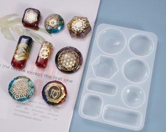 May include: A clear silicone mold with 10 different shapes for resin casting. The mold is on a white surface with several colorful resin pieces with geometric designs.