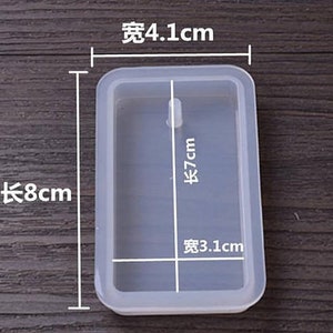May include: A clear rectangular silicone mold with measurements in centimeters. The mold is 8 cm long, 7 cm tall, and 4.1 cm wide. The mold is designed to create a rectangular shape with a small hole in the center.