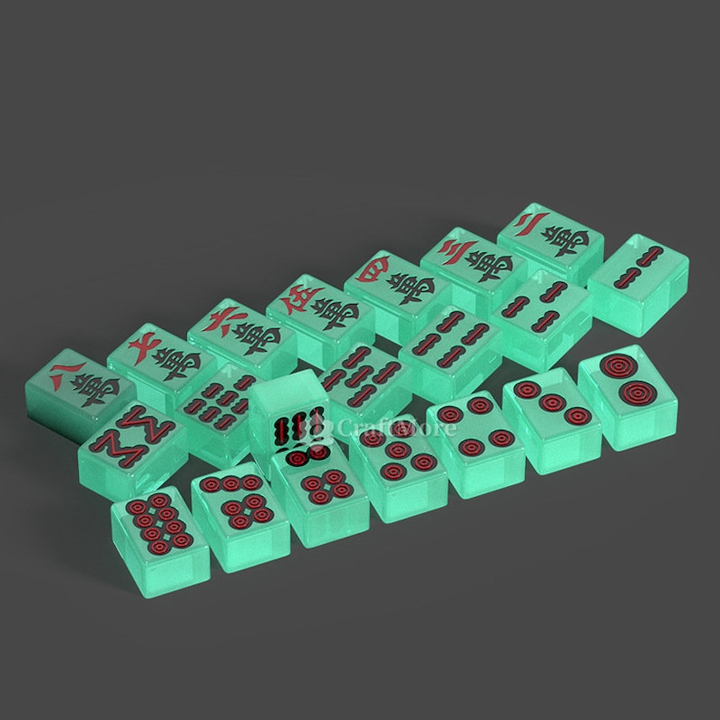 May include: A set of 18 green mahjong tiles with black and red characters and dots. The tiles are arranged in a staggered pattern.