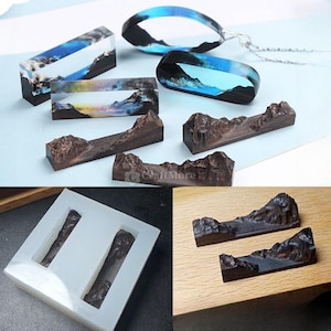 May include: Two silicone molds for resin casting, each with two rectangular cavities. The molds are white and have a smooth surface. The cavities are shaped like mountains with a valley in the middle. The molds are shown next to two finished resin castings, which are brown and have a textured surface. The castings are shaped like mountains with a valley in the middle. The castings are on a wooden surface.
