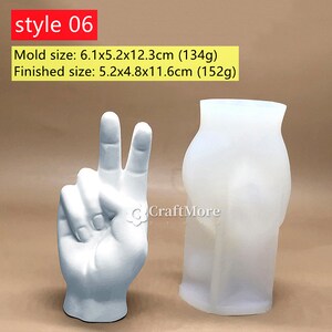 May include: Two silicone molds for making concrete crafts. One mold is shaped like a hand making a peace sign. The other mold is shaped like a vase. The molds are white and are sitting on a brown surface. Mold size: 6.1x5.2x12.3 inches (134g). Finished size: 5.2x4.8x11.6 inches (152g).