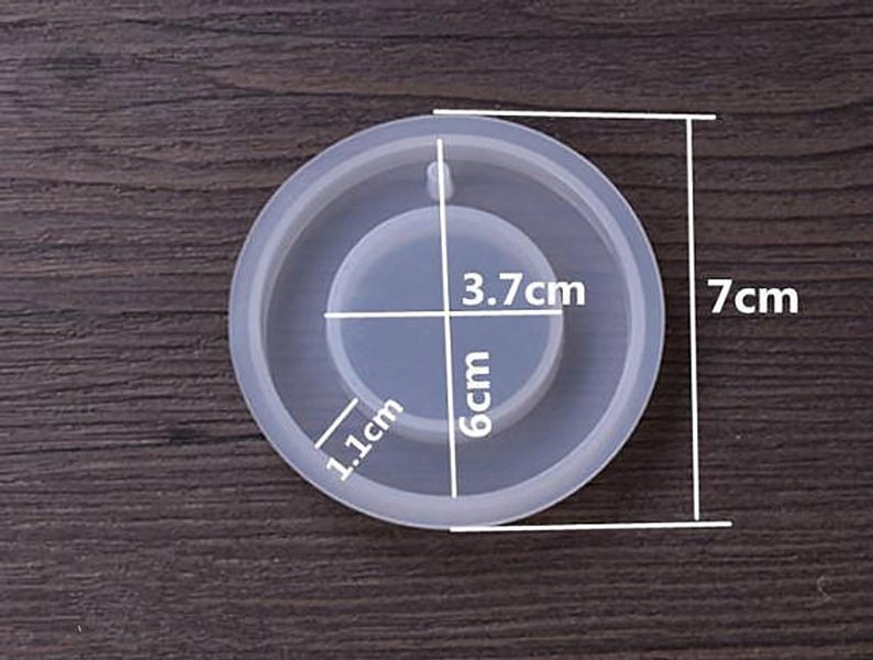May include: A clear silicone mold for resin crafts. The mold is 7 inches in diameter and has a circular indentation in the center that is 3.7 inches in diameter. The indentation is 1.1 inches wide and 6 centimeters deep.