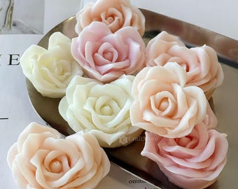 May include: Assortment of handmade soap roses in various shades of pink and white. The roses are arranged on a silver tray.