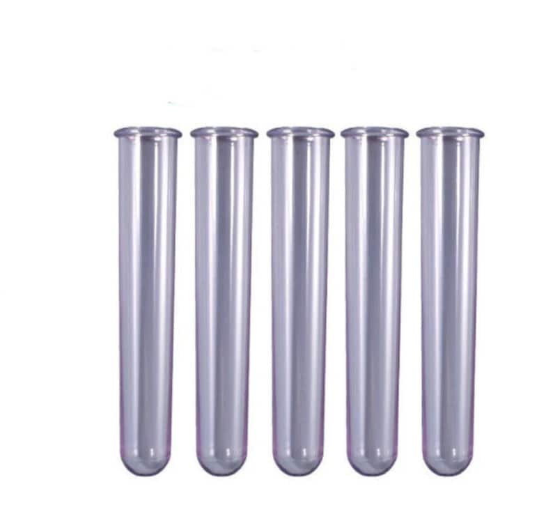 May include: Five clear plastic test tubes, all the same size and shape, standing upright in a row.