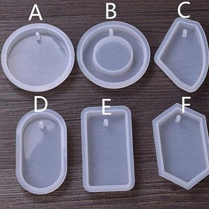 May include: Six clear silicone molds for making resin jewelry. The molds are shaped like a circle, oval, rectangle, hexagon, and two different teardrop shapes. Each mold has a small hole at the top for adding a bail or jump ring.