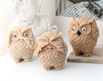 May include: Three brown owl-shaped candles with the word "Smile" on a small flag on each candle.