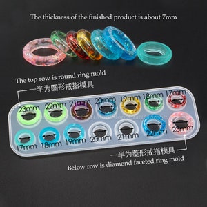 May include: A clear silicone mold for making resin rings. The mold has two rows of ring sizes, ranging from 17mm to 23mm. The top row is for round rings, and the bottom row is for diamond faceted rings. The text "The thickness of the finished product is about 7mm" is visible at the top of the image. The text "一半为圆形戒指模具" is visible above the top row of the mold. The text "一半为菱形戒指模具" is visible below the bottom row of the mold. The text "Below row is diamond faceted ring mold" is visible at the bottom of the image.