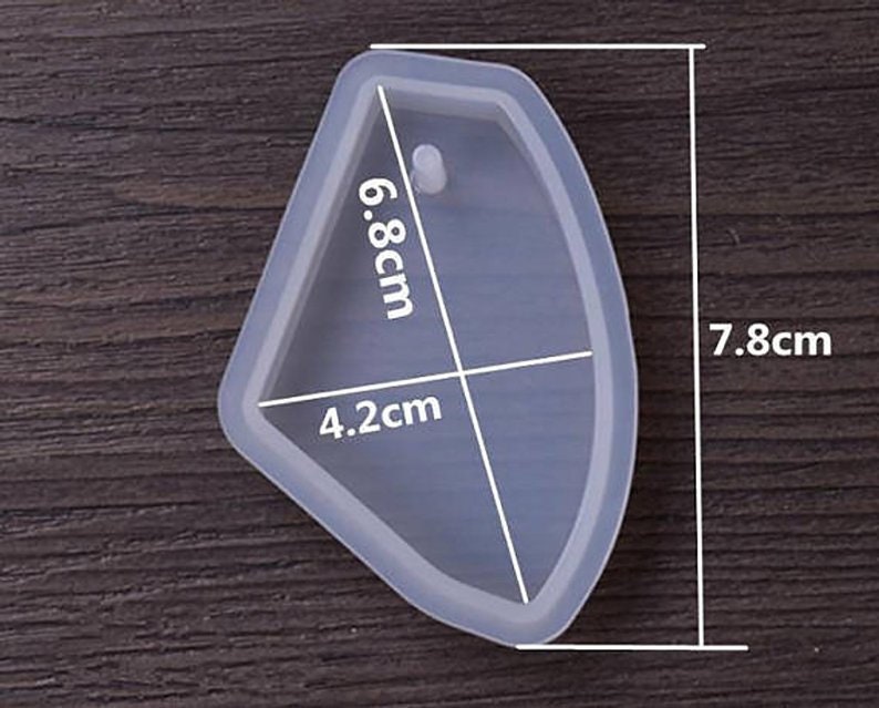 May include: Clear silicone mold shaped like a leaf with a hole for a pendant. The mold measures 7.8 inches by 6.8 inches by 4.2 inches.