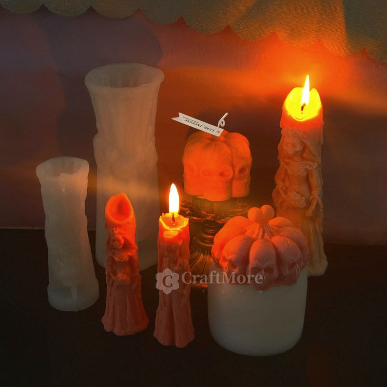 May include: Assortment of Halloween themed candles in various shapes and sizes.  The candles are made of a white and orange wax.  The candles are lit and glowing.  The text on the tag reads "TOADSTOOL PARTY".
