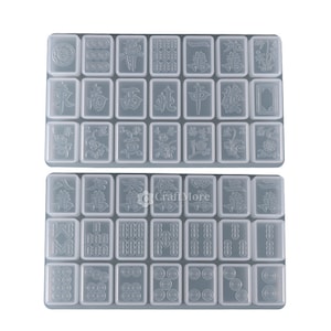 May include: Two clear plastic trays with 24 individual molds for making resin mahjong tiles. Each mold features a different mahjong tile design.