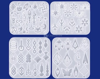May include: Four clear silicone molds with various earring designs. The molds feature a variety of shapes, including leaves, flowers, geometric shapes, and abstract designs. The molds are arranged on a dark blue background.